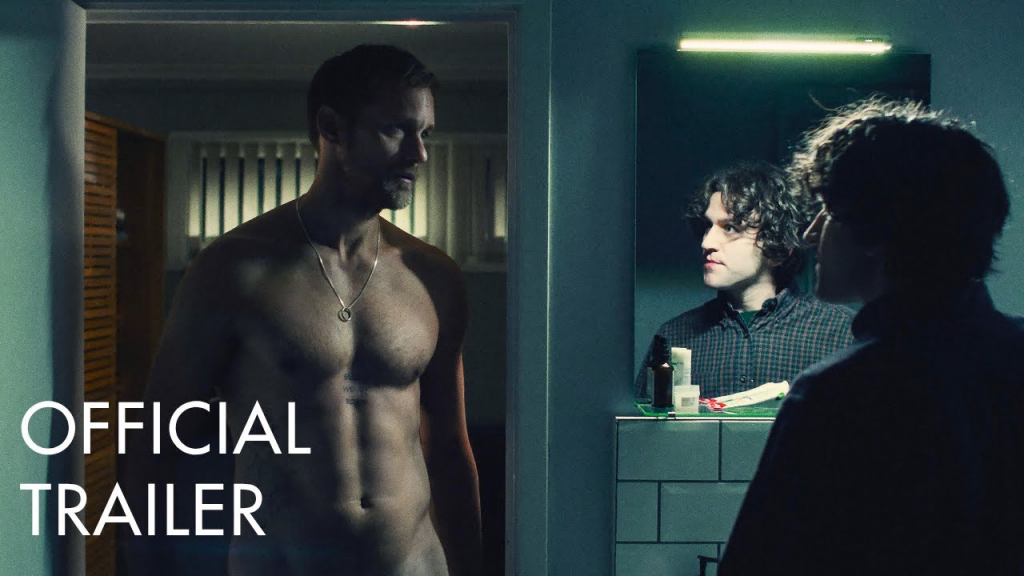 A still from the official trailer of the gay BDSM film Pillion (2025) where one can see (along with Colin) the three lines of female names tattooed on his epigastric region under the dim bathroom lighting.