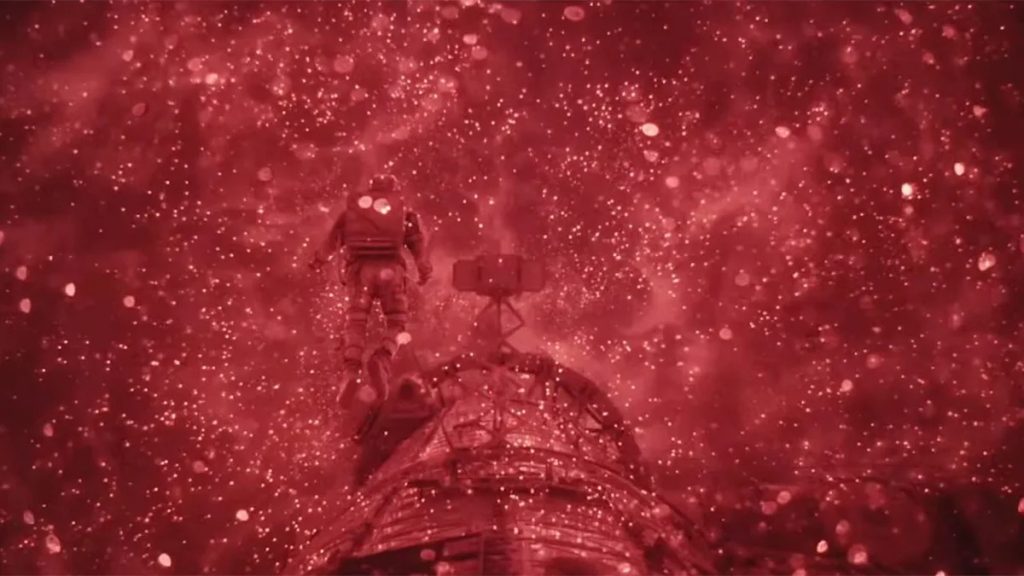 A still of the movie Project Hail Mary (2026) that shows the infra-red visualization of Astrophage in the Tau Ceti's Petrova line. One can see Grace walking on the space vessel while engulfed in a sea of shining red dots indicative of the Astrophage swarm.